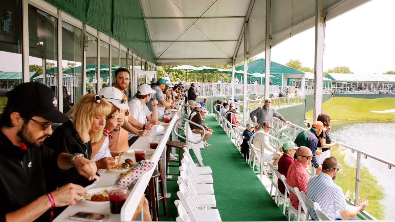 Guests dining and watching the course from a hospitality suite at the Good Good Championship in Texas.