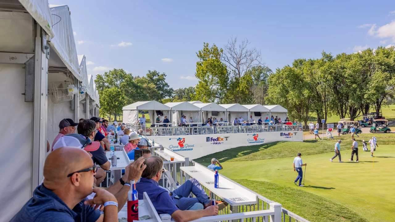 Guests watching golfers from a hospitality deck beside the green at the Good Good Championship in Texas.