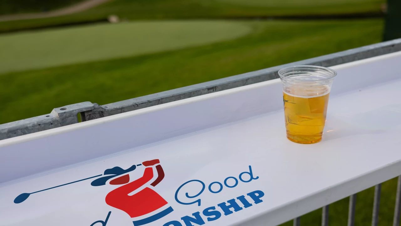 Drink resting on a Good Good Championship hospitality rail overlooking the golf course in Texas.