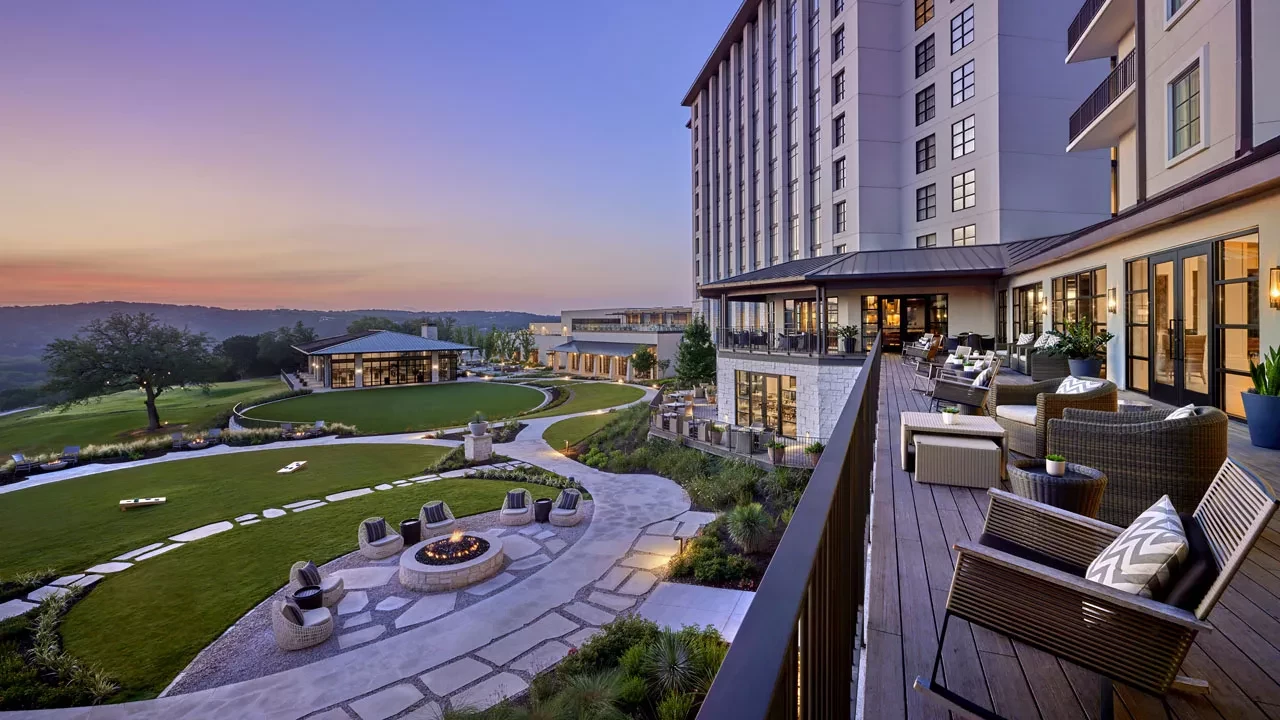 Outdoor terrace overlooking the Omni Barton Creek resort grounds at sunset in Austin, Texas.
